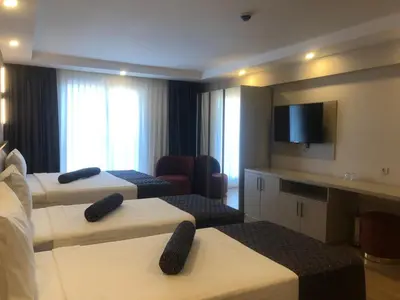 a hotel room with two beds and a flat screen tv at Grand İska Palace in Istanbul