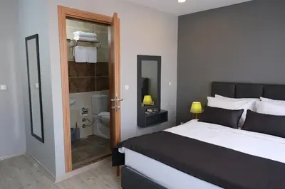 a bedroom with a large bed and a bathroom at Ore Pera Suites in Istanbul