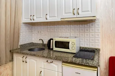a kitchen counter with a microwave and a sink at Alhambra Apart Hotel in Istanbul