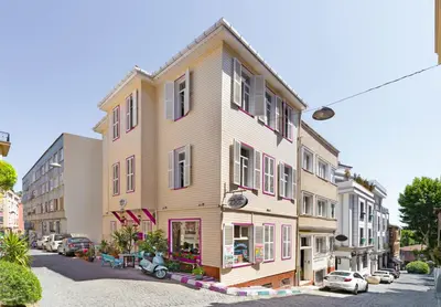 a building on a street with cars parked in front of it at Alhambra Apart Hotel in Istanbul