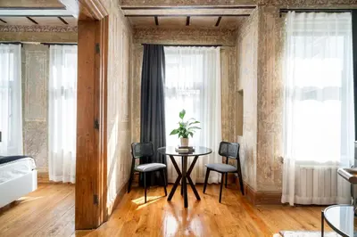 a room with a table and chairs and windows at Urban Quarters - Büklü Han in Istanbul