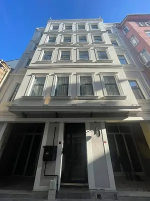 a large white building with the front door open at Urban Quarters - Büklü Han in Istanbul