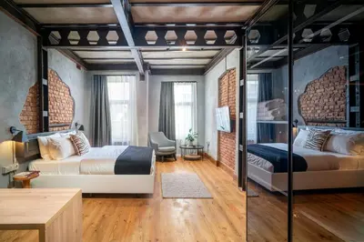 a bedroom with two beds and a desk in a room at Urban Quarters - Büklü Han in Istanbul