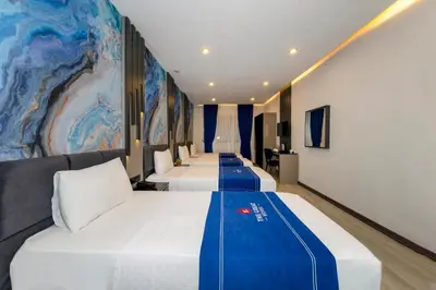 a row of beds in a hotel room at The Great Airport Hotel & Restaurant in Arnavutköy