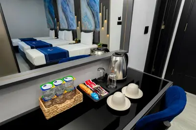 a room with a bed and a table with a mirror at The Great Airport Hotel & Restaurant in Arnavutköy
