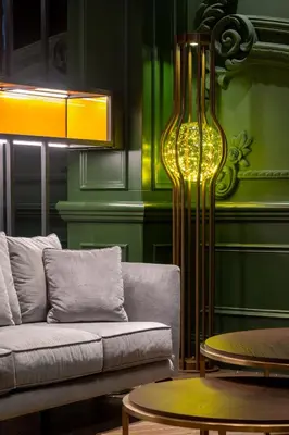 a living room with a couch and a lamp at Orient Occident Hotel Istanbul, Autograph Collection in Istanbul