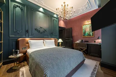 a bedroom with a bed and a bathroom with a sink at Orient Occident Hotel Istanbul, Autograph Collection in Istanbul
