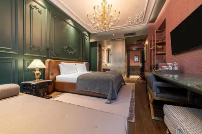 a bedroom with a bed and a desk in it at Orient Occident Hotel Istanbul, Autograph Collection in Istanbul