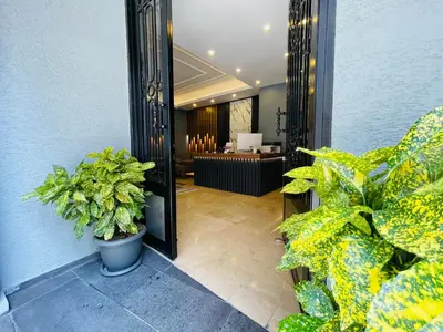a hallway with plants and a salon in the background at Meridiani Taksim Hotel in Istanbul
