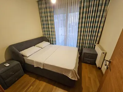 a small bedroom with a bed and a window at TAKSiM PERFECT RESiDENCE, 3 BEDROOMS, 140 M2, POOL GYM SAUNA ACCESS in Istanbul