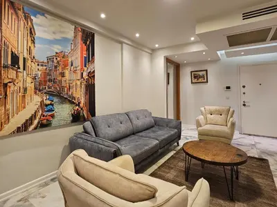 a living room with a couch and chairs and a painting at PERFECT RESİDENCE TAKSİM, 2 BEDROOM, POOL, Gym, Sauna in Istanbul