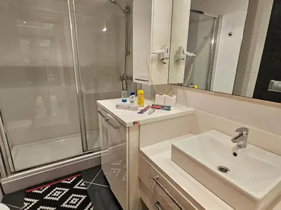 a bathroom with a sink and a shower at PERFECT RESİDENCE TAKSİM, 2 BEDROOM, POOL, Gym, Sauna in Istanbul