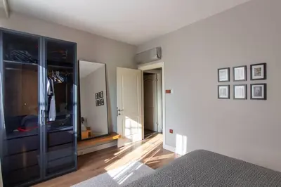 a living room with a bed and a dresser at Exclusive Vibrant 3BR Duplex w Terrace in Kadıköy! in Istanbul