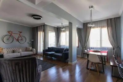a living room with a bike hanging on the wall at Exclusive Vibrant 3BR Duplex w Terrace in Kadıköy! in Istanbul