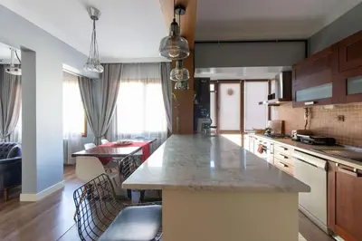 a kitchen with a large island in a room at Exclusive Vibrant 3BR Duplex w Terrace in Kadıköy! in Istanbul