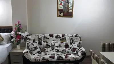 a living room with a couch with a blanket on it at BeyazitHan Suites Old City in Istanbul