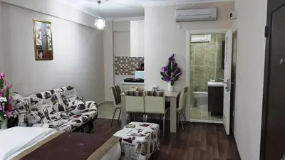 a room with a bed and a table and chairs at BeyazitHan Suites Old City in Istanbul