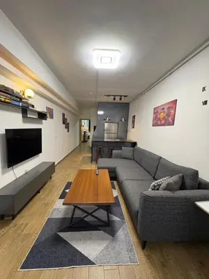 a living room with a couch and a table at Cosy flat nearTaksim/Nişantaşi in Istanbul