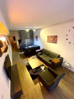 a living room with a couch and a piano at Cosy flat nearTaksim/Nişantaşi in Istanbul