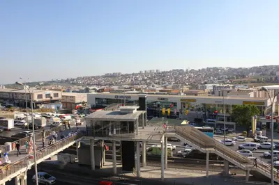 a city with a bridge and a parking lot with cars at Melidium Hotel in Beylikduzu