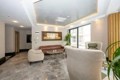 a lobby with a couch and chairs and a table at Hotel Ravi in Istanbul