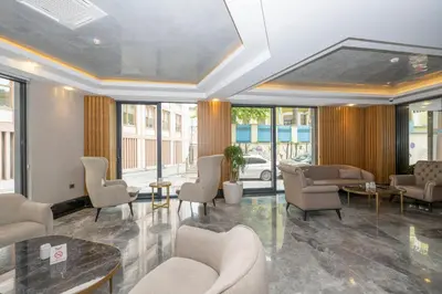 a waiting room with chairs and tables and windows at Hotel Ravi in Istanbul