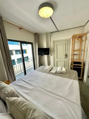 a bedroom with a large white bed with a window at Elegance House Hotel in Istanbul