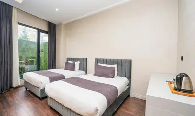 two beds in a room with a window at 216 Station Suite Gebze in Gebze