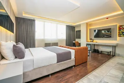 a hotel room with a bed and a desk at 216 Station Suite Gebze in Gebze