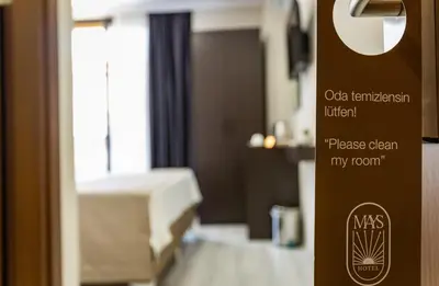 a hotel room with a bed and a sign in a door at Mays Royal Hotel in Istanbul