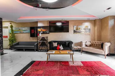 a living room with couches and a tv at Mays Royal Hotel in Istanbul