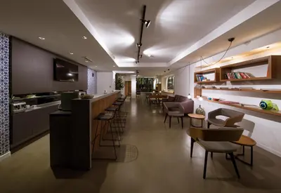 a restaurant with a bar and some chairs and tables at Alilass Hotel in Istanbul