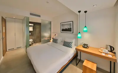 a bedroom with a large white bed and a desk at Alilass Hotel in Istanbul
