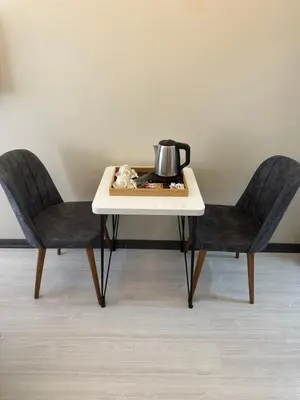 a table with two chairs and a tea kettle on it at Palladium APART Hotel in Istanbul