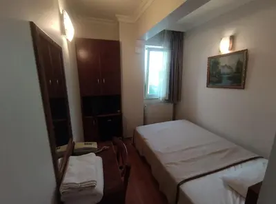 a small room with a bed and a mirror at Hotel Nayla in Istanbul