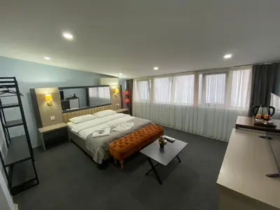 a bedroom with a large bed and a ladder at Kadıköy Linda Hotel in Istanbul