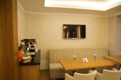 a dining room with a table and a couch at Besiktas Otel in Istanbul
