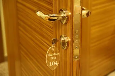 a wooden door with a key tag on it at Besiktas Otel in Istanbul