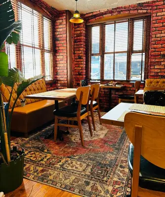 a room with a table and chairs and windows at Dimora Hotel Kadıköy in Istanbul
