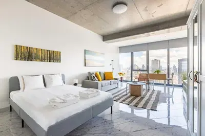 a bedroom with a bed and a living room at Scenic Bright Studio w Parking, PoolViews! #302 in Istanbul