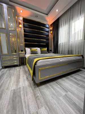 a bedroom with a large bed with a black headboard at TAKSİM LARİSSA RESİDENCE in Istanbul