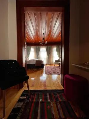 a living room with a door open to a living room at Lily Mansion in Istanbul