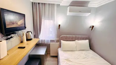 a hotel room with a bed and a tv at Taksim Centre Hotel in Istanbul