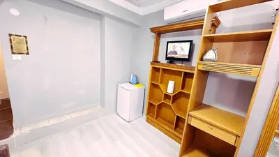 a room with a refrigerator and a shelf at Taksim Centre Hotel in Istanbul