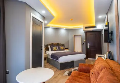 a hotel room with a bed and a couch at Viv City Hotel in Istanbul
