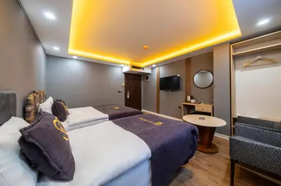 a hotel room with two beds and a tv at Viv City Hotel in Istanbul