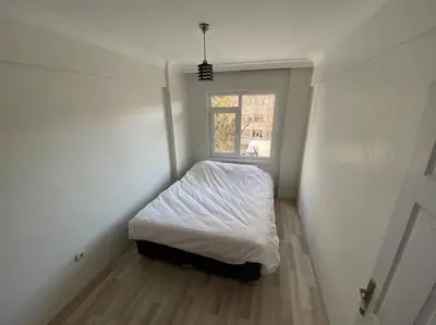 a small bedroom with a bed and a window at Large apartment with a balcony in central Kadıköy in Istanbul