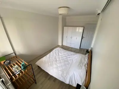 a small bedroom with a white bed in it at Large apartment with a balcony in central Kadıköy in Istanbul