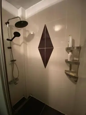 a bathroom with a shower with a black at Large apartment with a balcony in central Kadıköy in Istanbul