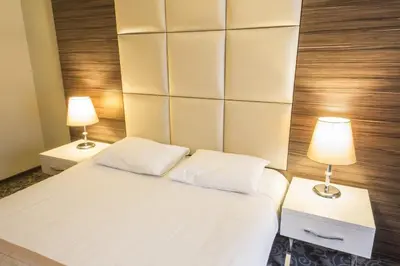 a bedroom with a large white bed with two lamps at Derpa Suite Hotel in Istanbul